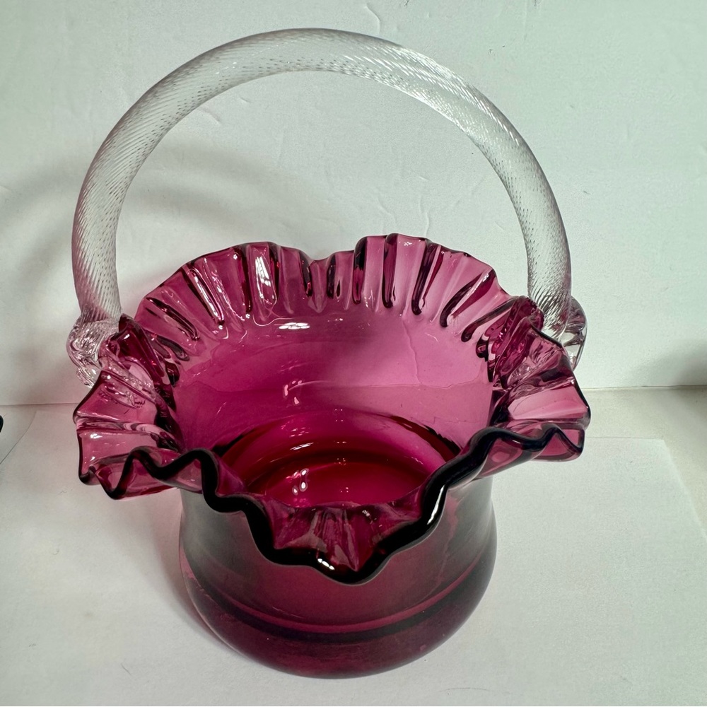 Beautiful vintage cranberry blown glass basket. Applied clear “rope style”handle